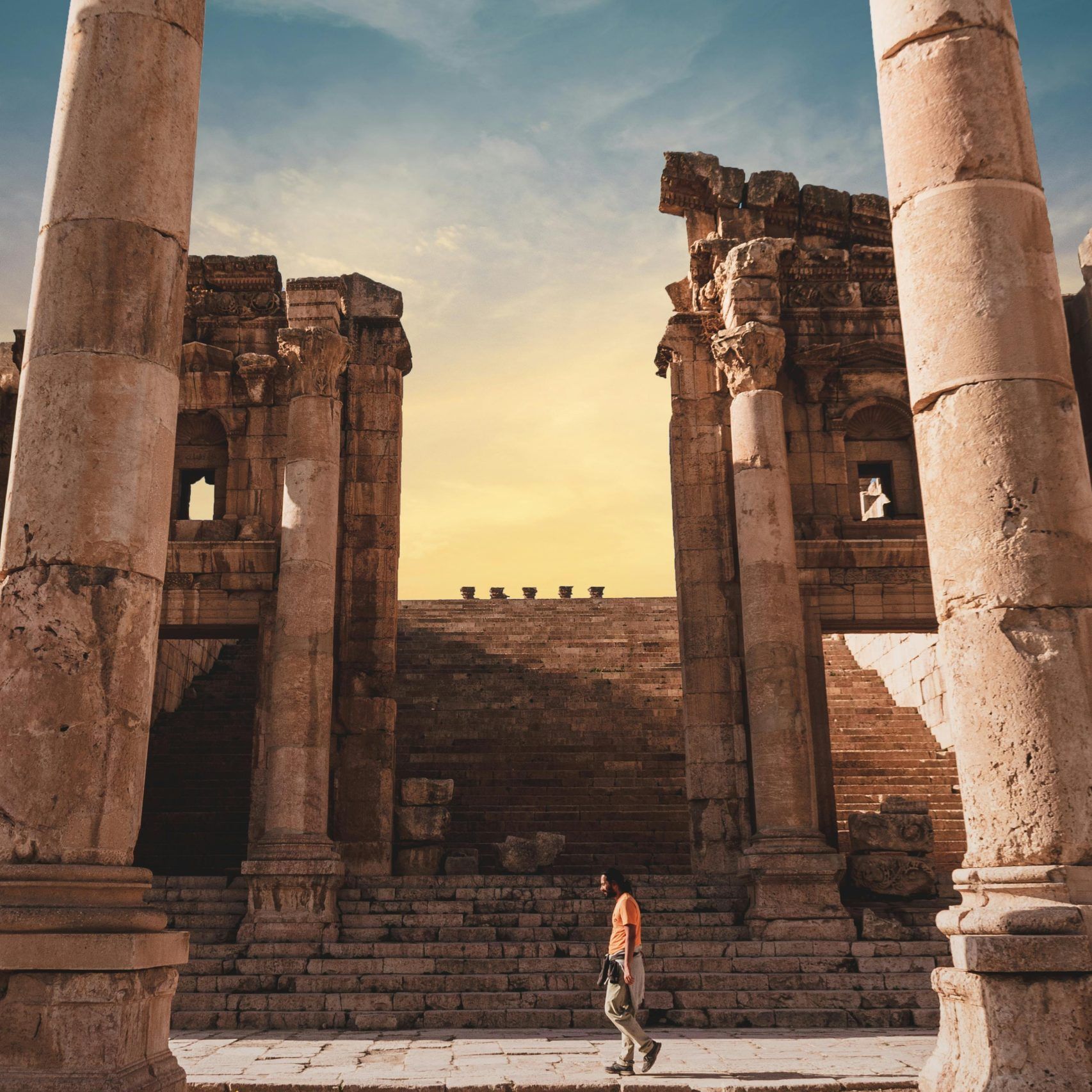 Petra, Jordan, where a solitary figure stands amidst the monumental wonder
