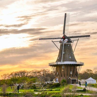 a traditional windmill against a scenic backdrop in holland